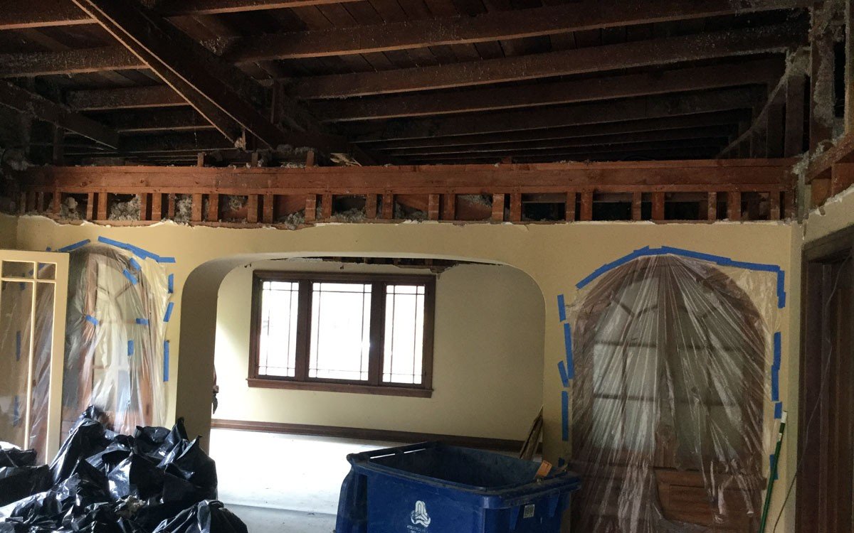 Guesthouse interior during demolition with ceiling and wall framing exposed