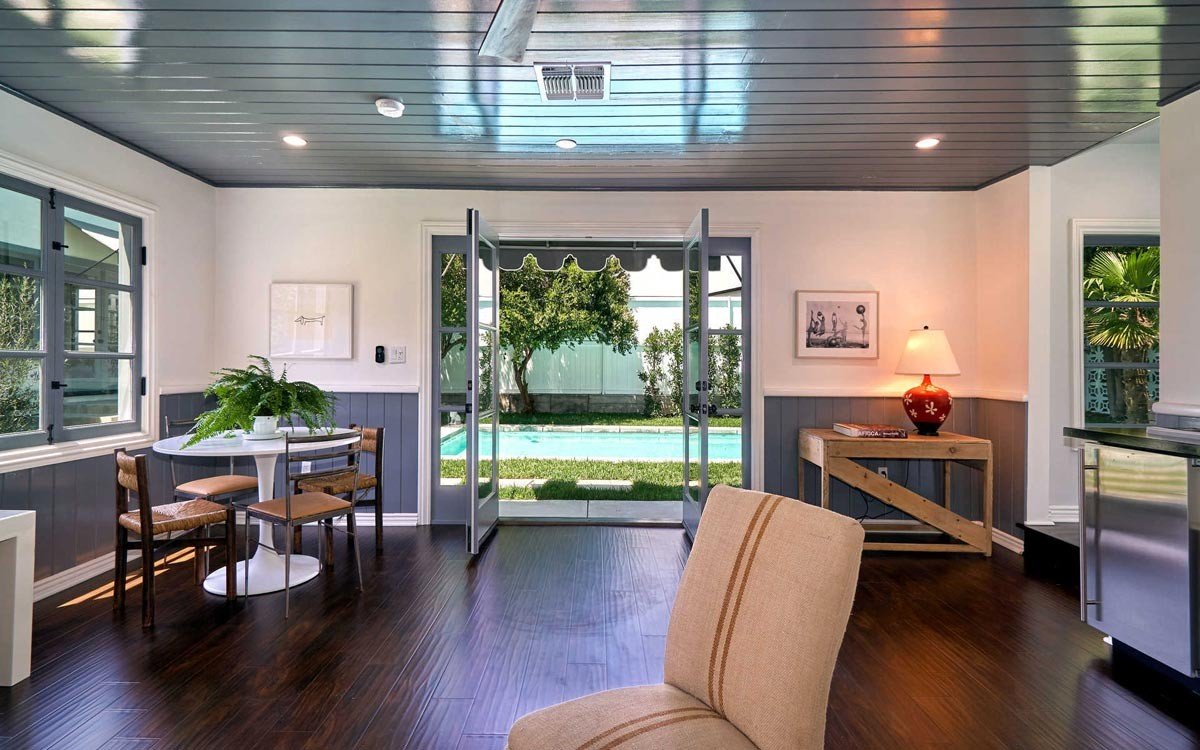 Finished guesthouse interior with French doors opening toward the pool