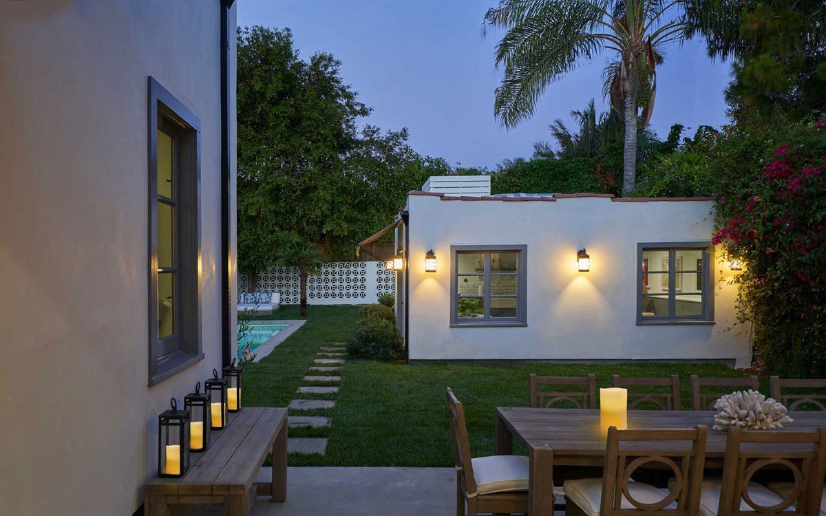 Renovated Brookside guesthouse at dusk viewed from the main residence patio