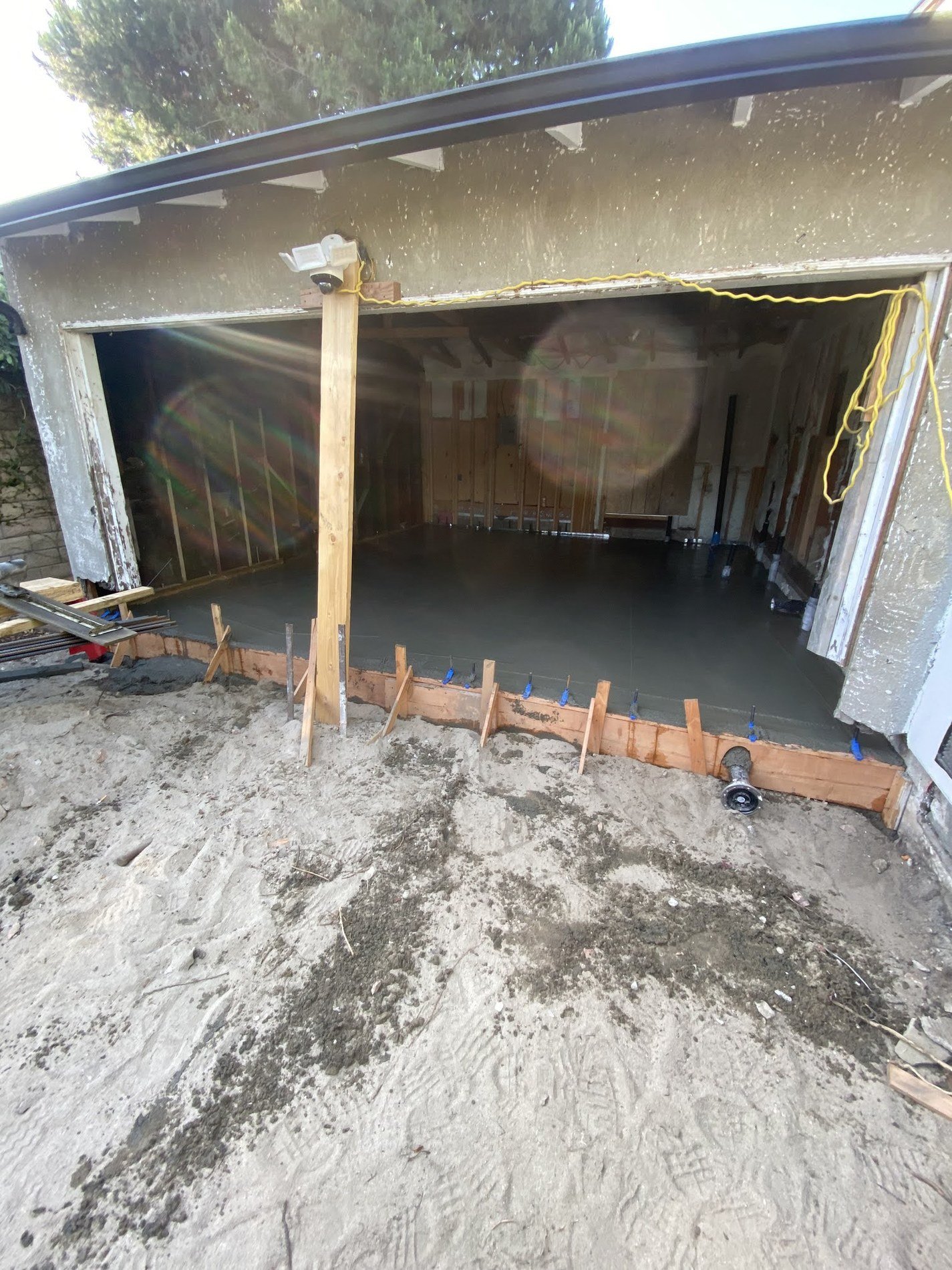 Fresh concrete slab work at the former garage opening during the ADU conversion