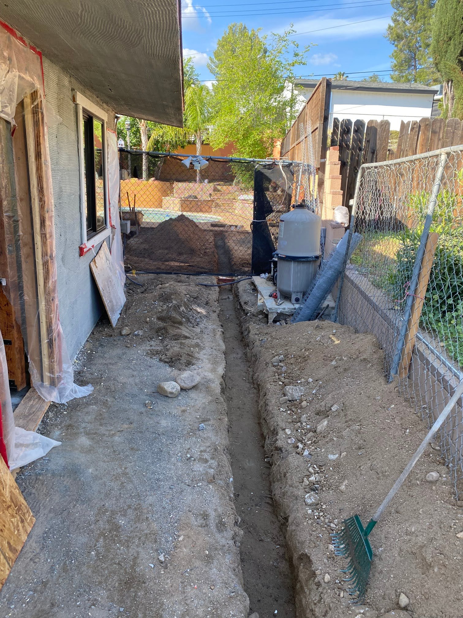Trenching and site preparation for the outdoor fence and tile project