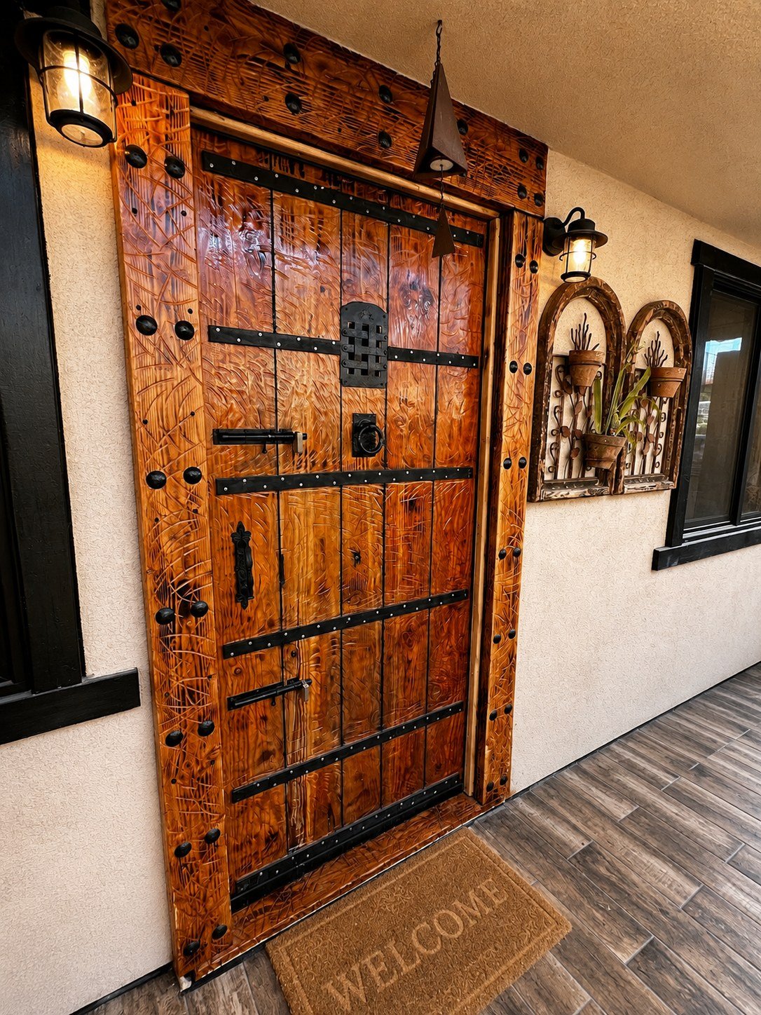 Handcrafted rustic wood entry door with black iron hardware